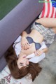 A woman laying on a couch with an American flag on it.