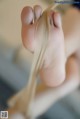 A close up of a person's feet tied up with a string.