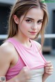 A woman in a pink tank top posing for a picture.